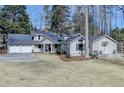 Charming single-Gathering home featuring a three-car garage and a cozy front porch at 617 Rock Springs Rd, Lawrenceville, GA 30043