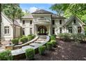 Elegant home with a stone walkway, manicured shrubs, and a charming balcony above the arched entryway at 760 River Gate Dr, Atlanta, GA 30350