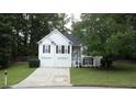 Charming two-story home with a well-maintained lawn, a two-car garage, and a welcoming blue front door at 262 Devynwood Ln, Dallas, GA 30157