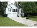 Inviting two-story home with a well-kept lawn, mailbox, and an attached two-car garage at 262 Devynwood Ln, Dallas, GA 30157