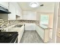Well-equipped kitchen featuring updated cabinets, counter tops, and sleek backsplash at 4363 Stonewall Tell Rd, Atlanta, GA 30349