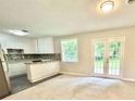 Open-concept living room boasting a stylish kitchen and bright, naturally lit spaces at 4363 Stonewall Tell Rd, Atlanta, GA 30349