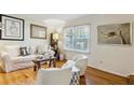 Cozy living area with hardwood floors, neutral palette, stylish furnishings, and a view of the outdoors at 162 Lablanc Nw Way, Atlanta, GA 30327
