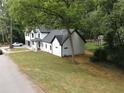 A tranquil aerial view showcasing the home, its freshly laid lawn, and the surrounding trees at 2764 Midway Rd, Decatur, GA 30030