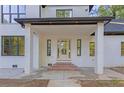Inviting covered front porch with brick steps leading to the glass front door at 2764 Midway Rd, Decatur, GA 30030