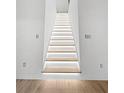 Modern staircase with ambient lighting and hardwood floors at 2764 Midway Rd, Decatur, GA 30030