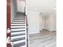 Inviting entryway features modern wood stairs and durable, stylish wood floors at 2973 Beaconwood Ct, Lawrenceville, GA 30043