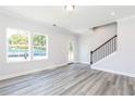 Bright living room with natural light, neutral walls, and elegant wood floors at 2973 Beaconwood Ct, Lawrenceville, GA 30043