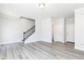 Spacious living room with neutral paint, wood floors, and modern lighting at 2973 Beaconwood Ct, Lawrenceville, GA 30043
