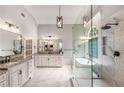 Luxurious bathroom features a glass enclosed shower, a soaking tub, and dual vanities at 5173 Brendlynn Dr, Suwanee, GA 30024
