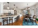 Open kitchen with an island, counter seating, and a breakfast nook with a table and chairs at 5173 Brendlynn Dr, Suwanee, GA 30024