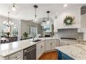 Bright, modern kitchen with granite countertops, stainless steel appliances, large island, and an open layout at 5173 Brendlynn Dr, Suwanee, GA 30024