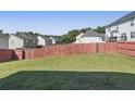 Large backyard with a well-maintained lawn surrounded by a wooden fence at 139 Palmetto St, Locust Grove, GA 30248