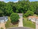 Aerial view of a two-story home surrounded by lush greenery in a peaceful neighborhood setting at 2623 Lone Oak Nw Trl, Kennesaw, GA 30144