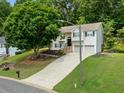 Suburban two-story home with manicured lawn, stone accents, black shutters, and a two-car garage at 2623 Lone Oak Nw Trl, Kennesaw, GA 30144
