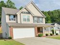 Attractive two-story home with vinyl siding, a two-car garage, and well-maintained landscaping at 5421 Skylar Creek Ln, Buford, GA 30518