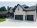 Stunning home featuring a three-car garage, brick accents, and a spacious driveway at 1952 Azalea Dr, Lawrenceville, GA 30043