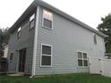 Back exterior view of the house with vinyl siding and sliding glass doors, and fenced yard at 215 Silver Spring St, Dallas, GA 30157