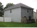 Rear view of home with vinyl siding, a small wooden deck, and a fenced-in backyard at 215 Silver Spring St, Dallas, GA 30157