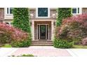 Detailed front entrance showcasing brickwork, decorative trees, and a classic front door at 4995 Aviary Nw Dr, Acworth, GA 30101