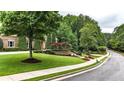 Street view of an impressive residence with a well-maintained lawn and mature trees at 4995 Aviary Nw Dr, Acworth, GA 30101