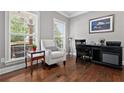 Cozy home office featuring a large window for natural light, hardwood floors, and ample workspace for productivity at 5365 Vendelay Ln, Cumming, GA 30040