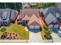 An aerial view of a brick home showing the roof, driveway and lawn at 836 Windsor Place Ct, Grayson, GA 30017