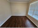 Cozy bedroom featuring hardwood floors and a window with natural light at 1021 Rock Elm Dr, Auburn, GA 30011