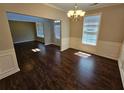 Dining room featuring hardwood floors, modern lighting, and wainscoting at 1021 Rock Elm Dr, Auburn, GA 30011
