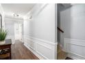 Inviting hallway featuring decorative wainscoting and hardwood floors at 1879 Beaver Dam Ne Ln, Marietta, GA 30062