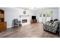 Cozy living room with a fireplace, hardwood floors, and plenty of natural light at 1879 Beaver Dam Ne Ln, Marietta, GA 30062