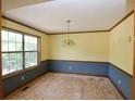 Dining room with yellow upper walls, blue lower walls, wood trim, and a light fixture at 1112 Mountain Springs Nw Dr, Kennesaw, GA 30144