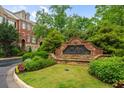 The Gates Parkside Village sign surrounded by lush greenery and landscaping at 1227 Parkside Village Nw Dr, Marietta, GA 30060