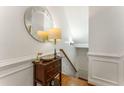 Elegant hallway with a decorative mirror, dark wood chest, and hardwood floors at 1227 Parkside Village Nw Dr, Marietta, GA 30060