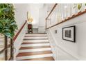 Bright foyer staircase with white risers, wood treads, and white railings at 1227 Parkside Village Nw Dr, Marietta, GA 30060
