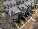 An exterior elevation showcases brick townhomes with private fenced yards and stairs leading to front doors at 124 Everley Walk, Alpharetta, GA 30009