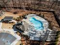 Aerial view of a community pool and amenity center surrounded by mature trees in a wooded neighborhood at 124 Everley Walk, Alpharetta, GA 30009