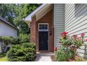 View of front door with brick detail and flowers at 1100 Ashbury Dr, Decatur, GA 30030