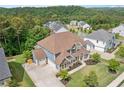 Two-story home with an expansive front lawn in a neighborhood surrounded by lush green hills and trees at 2121 Harmony Dr, Canton, GA 30115
