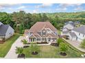A beautiful house with an expansive front lawn in a neighborhood surrounded by lush green hills and trees at 2121 Harmony Dr, Canton, GA 30115