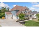 Two-story home with attached garages, well-manicured lawn, and stone accents on a sunny day at 2121 Harmony Dr, Canton, GA 30115