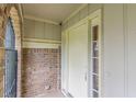 Close up of the front door, brick wall and covered porch entryway providing shelter from the elements at 3947 Veracruz Ct, Decatur, GA 30034
