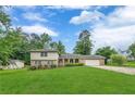Two-story home featuring a brick facade, manicured lawn, integrated garage, and mature trees at 3947 Veracruz Ct, Decatur, GA 30034