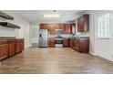 Spacious kitchen with stainless steel appliances and modern wood floor at 4938 Wewatta Sw St, Atlanta, GA 30331