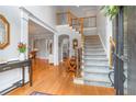 Traditional foyer with wood floors, stairs, and views to other rooms is warm and inviting at 9595 Rod Rd, Alpharetta, GA 30022