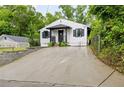 Inviting home with a long driveway, a quaint front porch, and a neatly kept lawn at 1268 Ladd Sw St, Atlanta, GA 30310