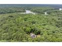 Beautiful aerial view of a home nestled among trees near a lake at 1678 Rabke Rd, Canton, GA 30114
