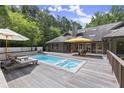 Inviting backyard pool with a spacious deck and lounge chairs, perfect for relaxation at 1678 Rabke Rd, Canton, GA 30114