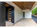 Modern home's inviting covered entryway, showcasing sleek black accents and a stylish glass-paneled front door at 178 Wesley Ne Ave # B, Atlanta, GA 30307