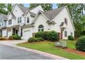 Well-maintained townhome featuring neutral siding, stone accents and a one-car garage nestled in a quiet neighborhood at 412 Mcafee Nw Ct # 14, Kennesaw, GA 30144